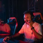 Two gamers immersed in an esports tournament, focused with headsets and keyboards. — Experience Real-Time Gaming Action and P