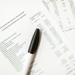 Financial documents featuring cash flows and pens, ideal for business themes and analysis. — Marginal Cost