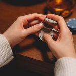 A person in a white sweater playing with poker chips on a wooden table. — What should you really understand to earn the most